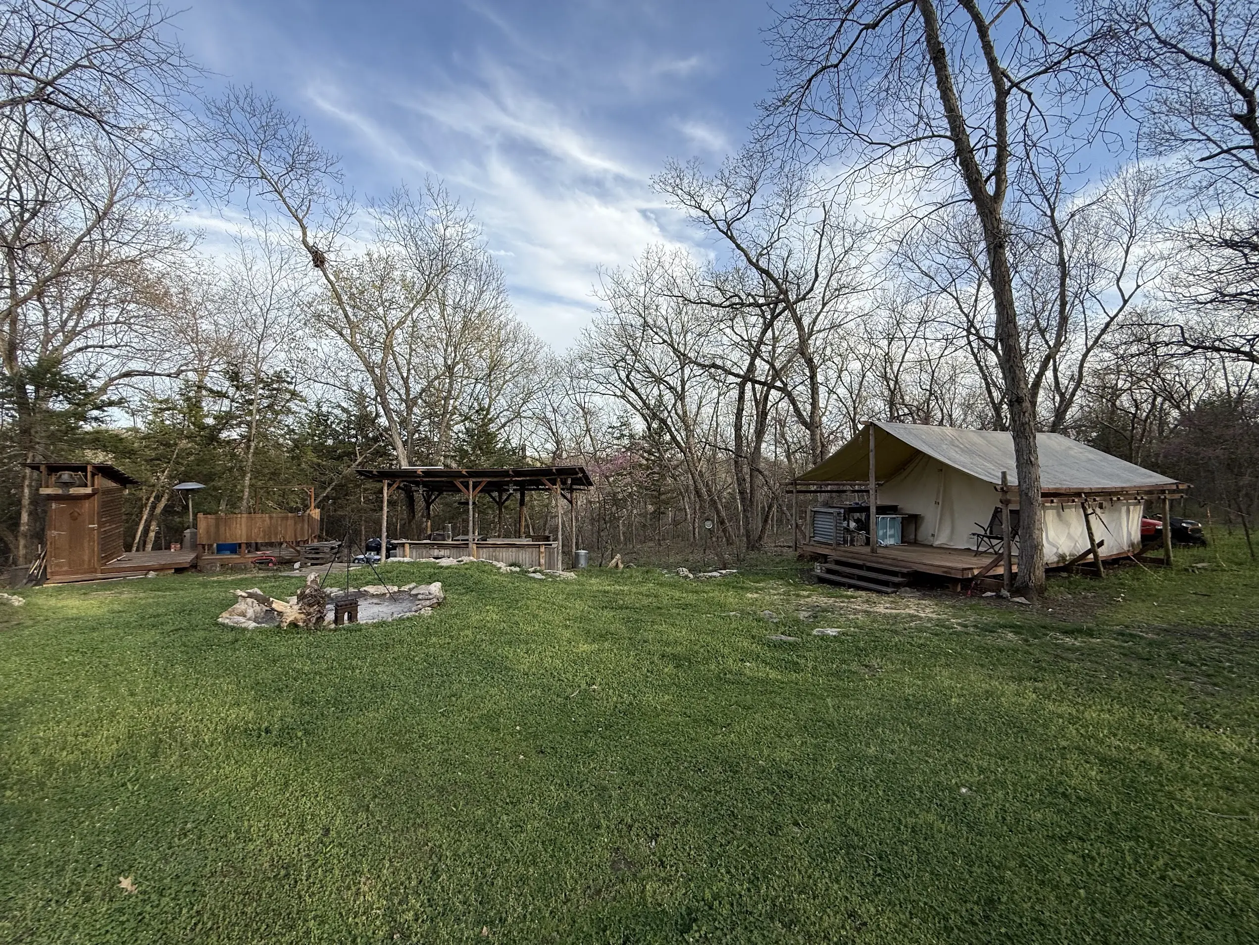 Camp clearing with cabin and structures