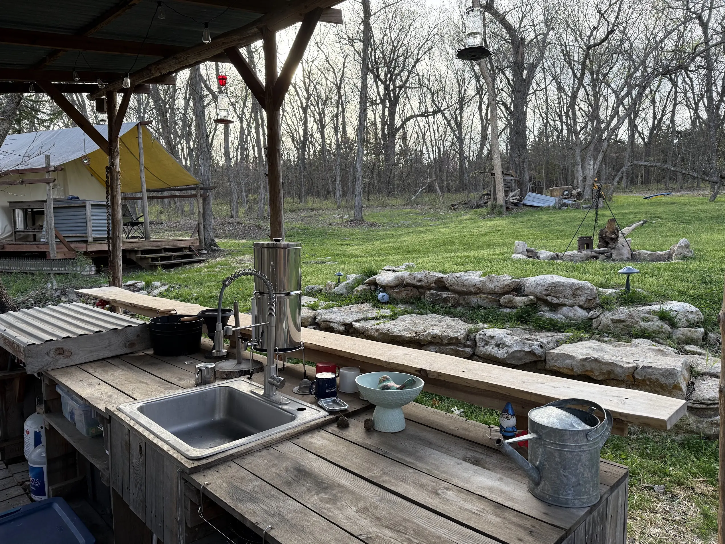 Camp kitchen area with sink and fire-ring seating